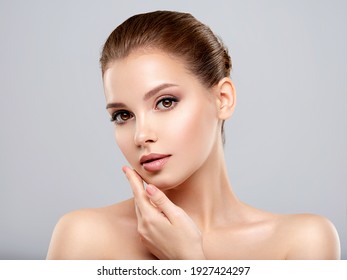 Closeup portrait of a  face of the young pretty girl with a healthy skin. Beautiful face of young white woman with a clean skin. Skin care concept.  - Shutterstock ID 1927424297