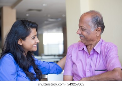 Closeup portrait, family, young woman in blue shirt affectionately gazing older man in pink collar button , happy isolated indoors home background