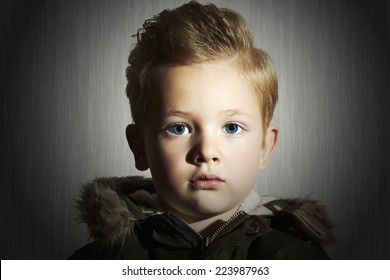 close-up portrait of Fashionable child in winter coat. fashion kid.children.khaki parka.little boy hairstyle