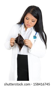 Closeup Portrait Of A Female Healthcare Professional Looking Sad And Miserable By Her Empty Wallet Isolated On A White Background. Health Care Reform, Medicare Plan, Reimbursement Debate Concept