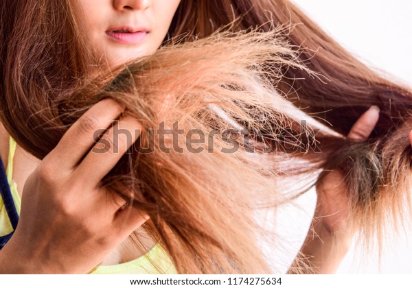 Closeup portrait of\
female model holding messy hair in hands, Combing with brush and\
pulls long hair, Daily preparation for looking nice, Long\
Disheveled Hair, Holding Messy\
Hair