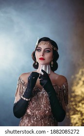 Closeup portrait flapper woman with glass of red wine. golden headband, finger wave hairstyle, vintage style 20s dress evening makeup bright lips. Backdrop room, smoke. Elegant trendy image for party