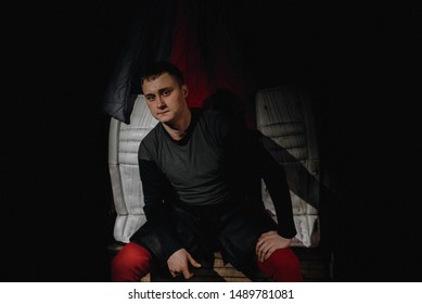 Closeup Portrait Of A Focused Hockey Goalie. Sports Photography. A Professional Ice-hockey Player In Uniform.