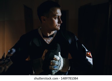 Closeup Portrait Of A Focused Hockey Goalie. Sports Photography. A Professional Ice-hockey Player In Uniform.