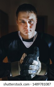 Closeup Portrait Of A Focused Hockey Goalie. Sports Photography. A Professional Ice-hockey Player In Uniform.