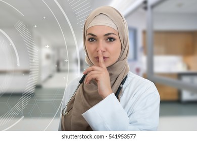 Closeup Portrait Of Friendly, Confident Muslim With Hijab Doctor Showing Shh Sigh, Silence.