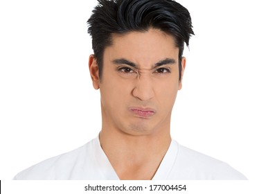 Closeup Portrait Of Funny Young Man Puckering Lips, With Look Of Disgust On Face, Bad Crap Bitter Taste In Oral Mouth Cavity, Isolated On White Background. Negative Emotion Facial Expression Feelings.