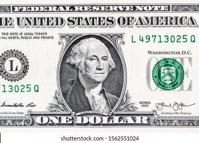 Close-up portrait of George Washington on a US 1 dollar banknote.