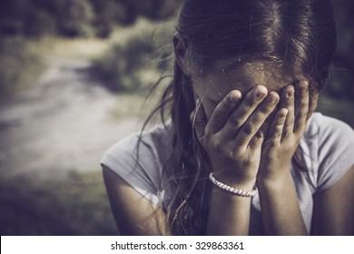 Close-up Portrait Of A Girl Crying And Covering Her Face