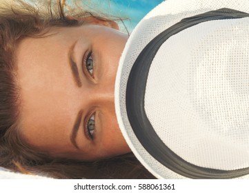 Closeup Portrait Of Gorgeous Woman Cover The Face A Sun Hat While Lying On The Beach