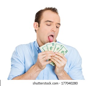 Closeup Portrait Of Greedy Banker, CEO Boss, Corporate Employee, Crazy Guy,  Funny Looking Man Obsessed, Licking Cash, Money, Dollars With Tongue, Isolated On White Background. Expressions, Emotions