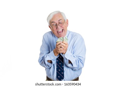 Closeup Portrait Of Greedy Senior Executive, CEO, Boss, Old Corporate Employee, Mature Man, Shaking, Holding Dollar Banknotes, Isolated On White Background. Negative Human Emotion Facial Expression