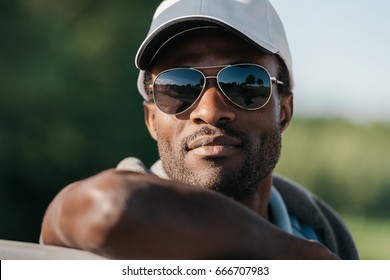 Close-up Portrait Of Handsome African American Man In Cap And Sunglasses