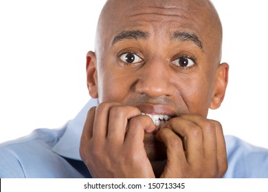 closeup portrait of handsome bald man scared and afraid with fingers in mouth, isolated on white background