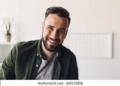 Close-up Portrait Of Handsome Bearded Man Smiling At Camera