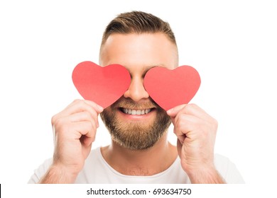 Close-up portrait of handsome bearded man closing eyes by red paper hearts, isolated on white - Powered by Shutterstock