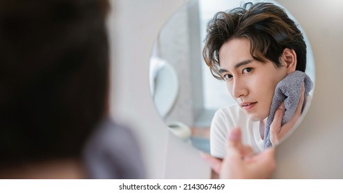 Closeup Portrait Of Handsome Beautiful Asian Boy With Mirror Makeup Routine With Copy Space. Beauty Influencer Guy With Perfect Glow Skin Dress Up. Healthcare Man Lifestyle Cosmetic Blogger Concept