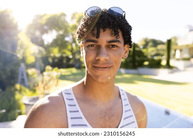 Close-up portrait of handsome biracial young man with sunglasses posing in yard against clear sky. Copy space, unaltered, face, smiling, fashion, dreadlocks, lifestyle and summer concept. - Powered by Shutterstock