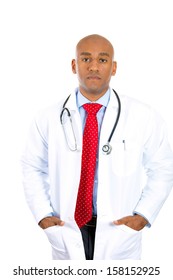 Closeup Portrait Of Handsome Confident Health Care Professional, Young Male Doctor, Nurse With Stethoscope, Hands In Lab Coat, Isolated On White Background. Patient Visit, Medicaid Reimbursement