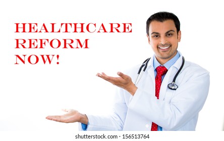 Closeup Portrait Of Handsome Health Care Professional Pointing To Healthcare Reform Now Sign, Isolated On White Background