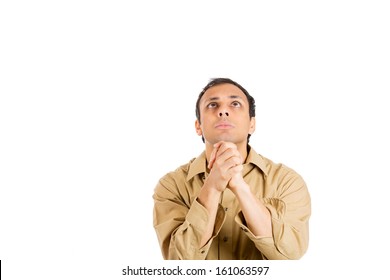 Closeup portrait of an handsome man in brown shirt, looking upwards to sky with hands clasped praying asking for a miracle or sign, isolated on white background with copy space. Positive human emotion - Shutterstock ID 161063597