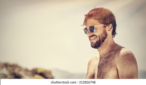 Closeup Portrait Of Handsome Man Wearing Stylish Sunglasses, Fashionable Attractive Model On The Beach, Summer Vacation, Freedom And Pleasure Concept