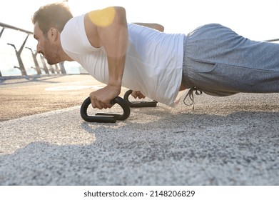 Close-up Portrait Of A Handsome Middle Aged European Man, Muscular Build Athlete, Sportsman Doing Push Ups Exercises During An Outdoor Workout On The City Bridge Early In The Morning At Dawn