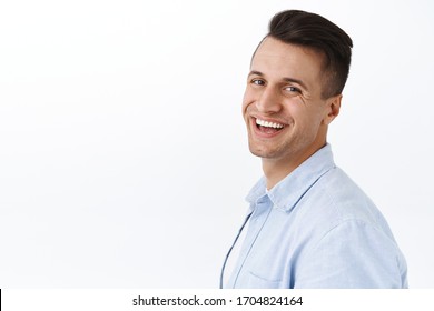 Close-up Portrait Of Handsome Stylish Young Man Standing In Profile, Turn Head To Camera With Beaming Smile, Express Satisfaction And Enthusiasm, Standing White Background Pleased