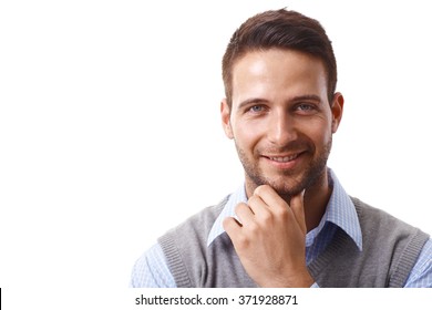 Closeup portrait of handsome young businessman smiling happy, looking at camera, hand on chin.