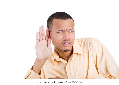 Closeup portrait of handsome young guy with blue shirt trying to secretly listen in on a conversation and not pleased by what he hears, privacy violation, isolated on white background with copy space