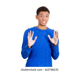 Closeup portrait of a handsome young man looking shocked, surprised in disbelief with arms palms in the air pushing away, isolated on white background. Negative human emotions facial expressions