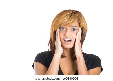 Closeup portrait of a happy cute young beautiful woman looking shocked and surprised in full disbelief hands on cheeks, isolated on a white background. Negative human emotions and facial expressions