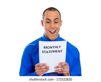 Closeup Portrait Of Happy Excited Young Man Looking At Monthly Statement Glad To Pay Off Bills, Isolated On White Background. Positive Emotion Facial Expression Feelings. Financial Success, Good News