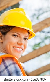 Closeup Portrait Of Happy Female Construction Worker At Site