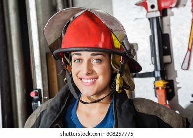 Closeup Portrait Of Happy Female Firefighter At Fire Station