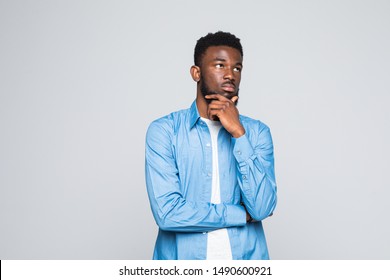 Closeup portrait of happy guy, young handsome man looking up sideways dreaming, remembering good times hand on chin, isolated on white background. Positive human emotions, facial expression, feelings