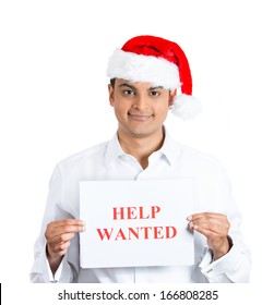 Closeup Portrait Of Happy Handsome Confident Young Man In Red Santa Claus Hat Holding A Help Wanted Sign With Hands, Isolated On White Background. Positive Emotion Facial Expression Feelings