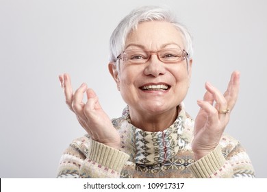 Closeup Portrait Of Happy Old Woman Gesturing By Hands.
