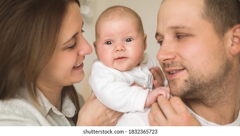 Closeup portrait of happy parents playing with their baby