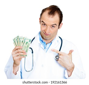 Closeup portrait happy, sarcastic male health care professional, business man doctor holding dollar bills, cash, money in hand, isolated white background. Human emotions facial expressions, attitude