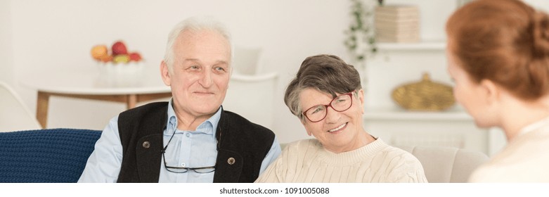 Close-up Portrait Of Happy Senior Man And Woman Looking At A Counselor In Marriage Therapy Session