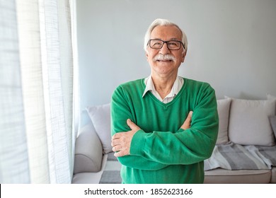 Close-up Portrait Of Happy Senior Man Looking At Camera. Portrait Elderly Man At Home. Elderly Man Smiling Face Expression Concept. Happy Smiling 70 Year Old Elder Senior Man Portrait