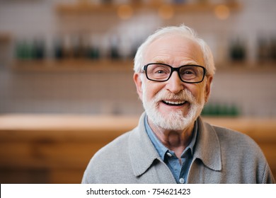 close-up portrait of happy senior man looking at camera