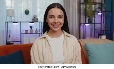 Close-up Portrait Of Happy Smiling Caucasian Girl In Shirt, Looking At Camera, Celebrate Good News. Young Woman Indoor Isolated At Home In Living Room Sitting On Orange Couch. Female Nature Beauty