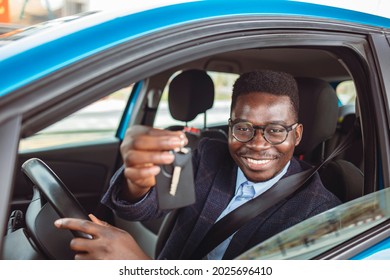 Closeup Portrait Happy, Smiling, Young Man, Buyer Sitting In His New Blue Car Showing Keys Isolated Outside Dealer, Dealership Lot. Personal Transportation, Auto Purchase Concept