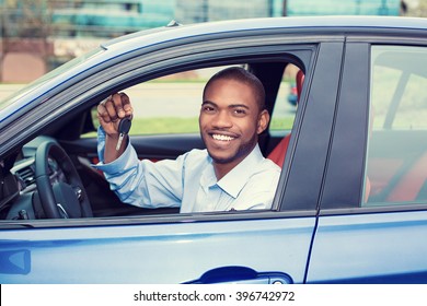 Closeup Portrait Happy, Smiling, Young Man, Buyer Sitting In His New Blue Car Showing Keys Isolated Outside Dealer, Dealership Lot. Personal Transportation, Auto Purchase Concept