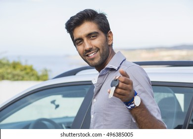 Closeup Portrait Happy, Smiling, Young Man, Buyer Showing Keys Of His New Car  Isolated Outside Dealership Lot. Personal Transportation, Auto Purchase Concept