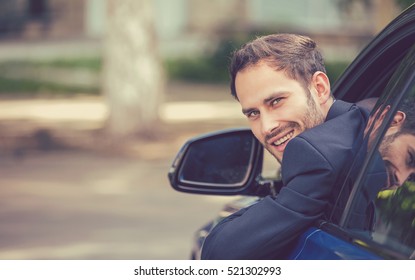 Closeup Portrait Happy Smiling Young Man Buyer Sitting In His New Car Excited Ready For Trip. Isolated Outside Dealer Dealership Lot Office. Personal Transportation Auto Purchase Concept