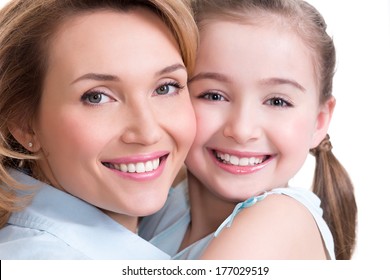CLoseup portrait of happy  white mother and young daughter - isolated. Happy family people concept.
