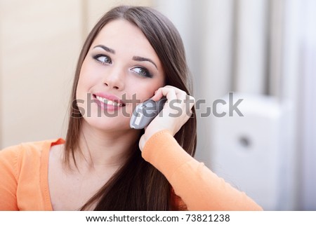 Closeup portrait of a happy woman on phone at home looking at copyspace
